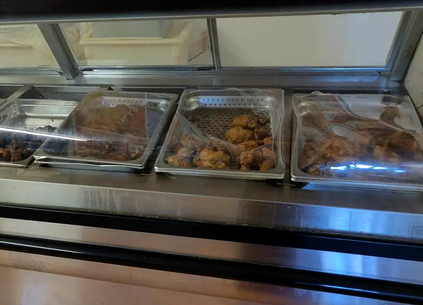 The Flores Jr. steam table with trays of chicharrón, carnitas and more.